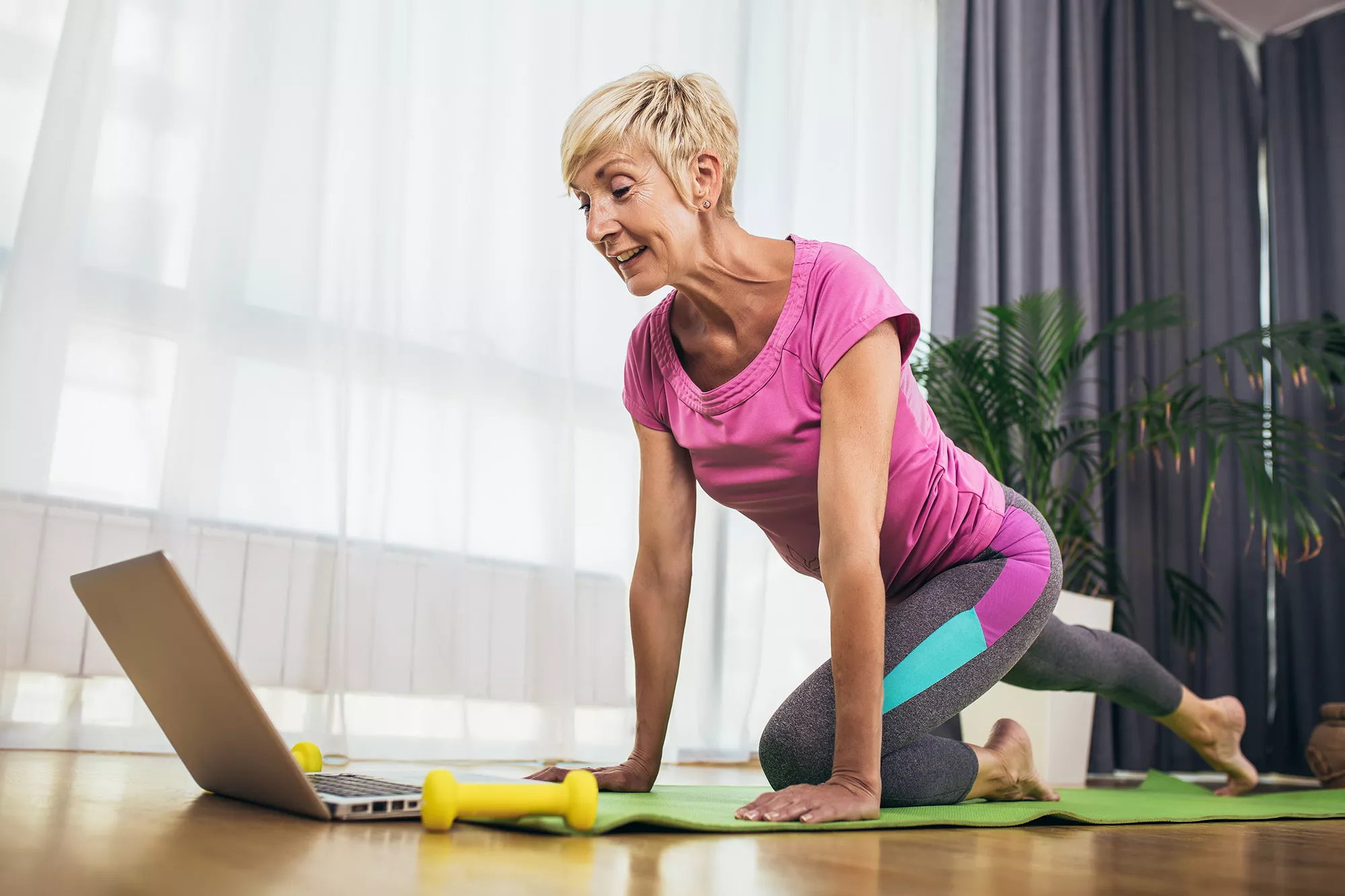 Mature Woman Using Virtual Y to Workout at Home