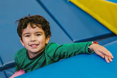 Young Boy on Blue Play Mats