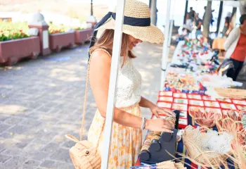 women browsing tables at an outdoor market