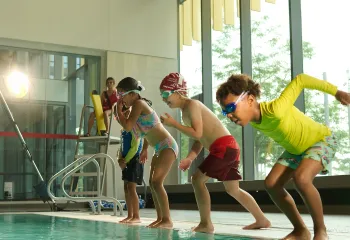 kids jumping into pool