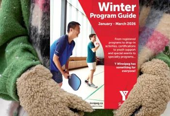 pair of hands in mittens holding the program guide