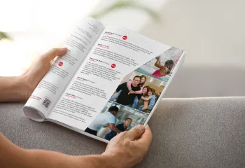 hands holding open a program guide