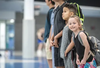 smiling youth with backpacks