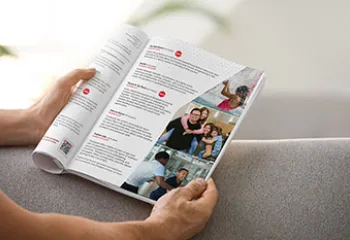 hands holding open a program guide