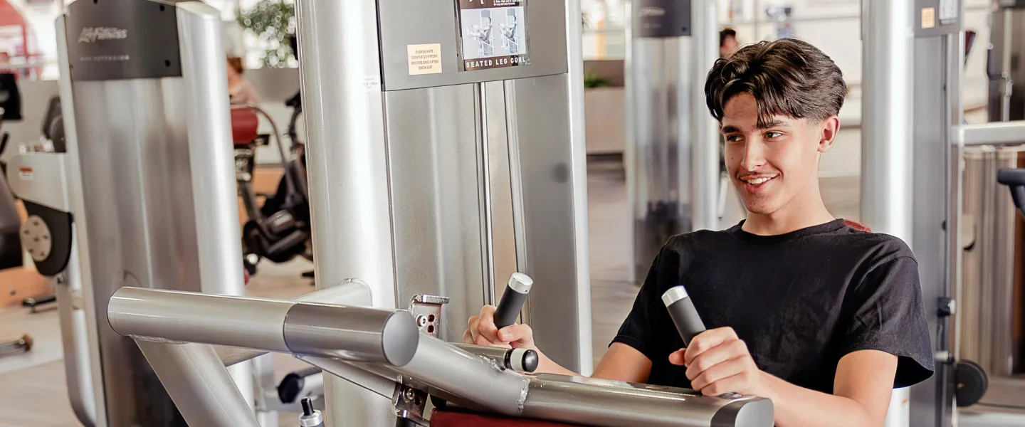 Teen boy using fitness centre at West Portage Y