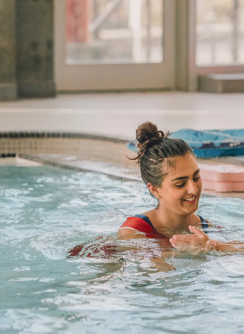 Y staff teaching child to swim