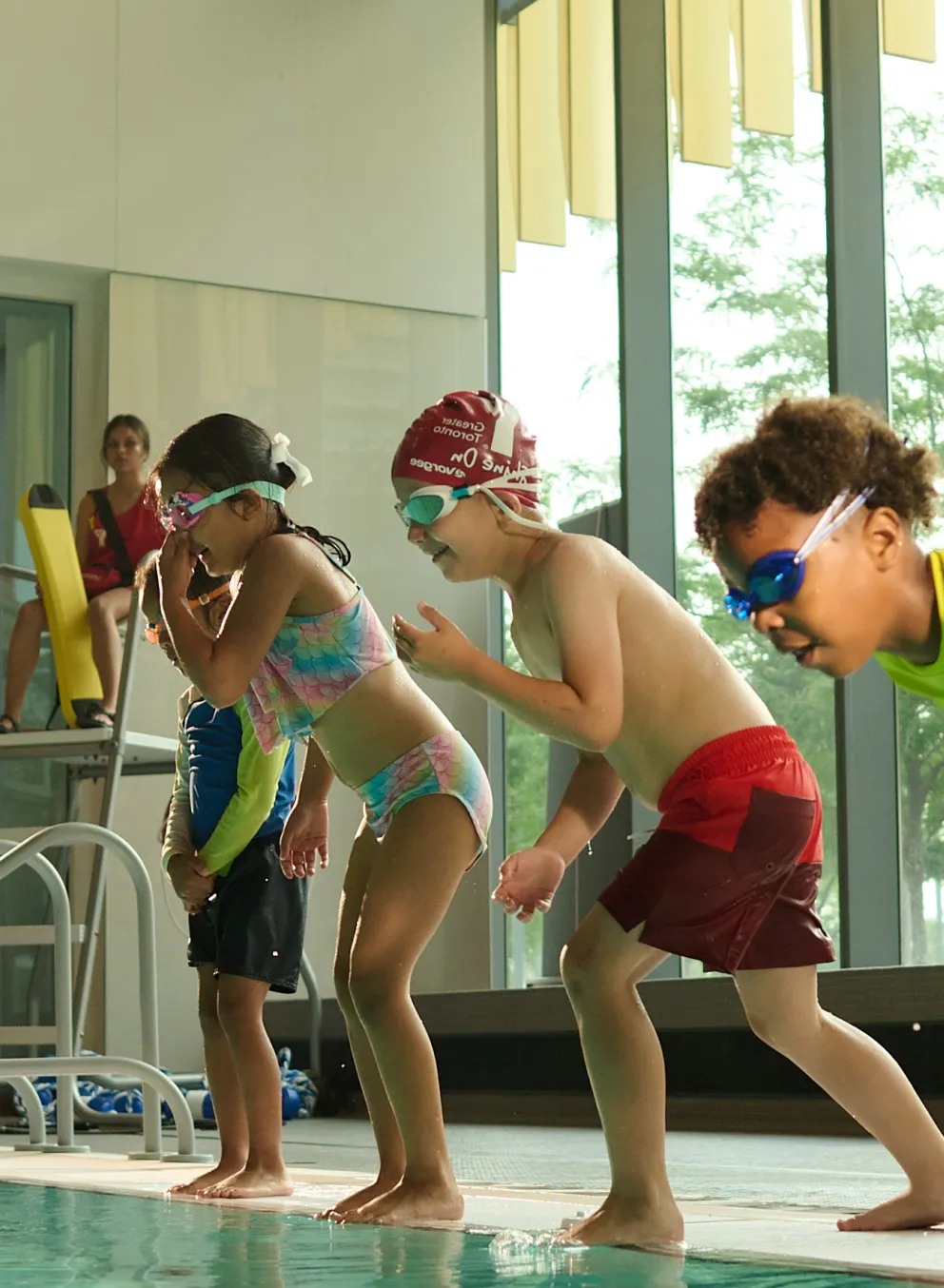 kids jumping into pool