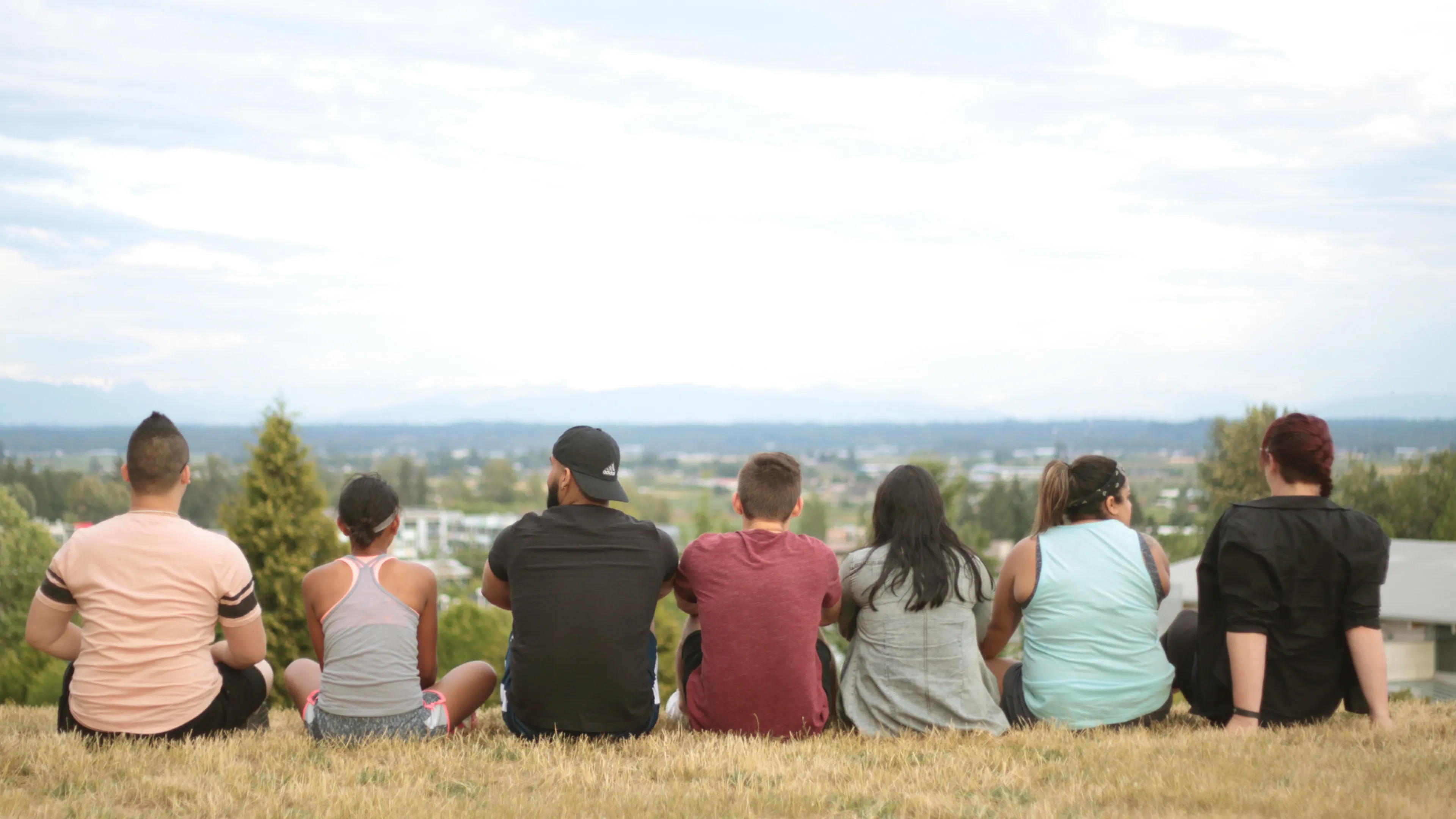Young Adults Sitting and Looking at the Horizon
