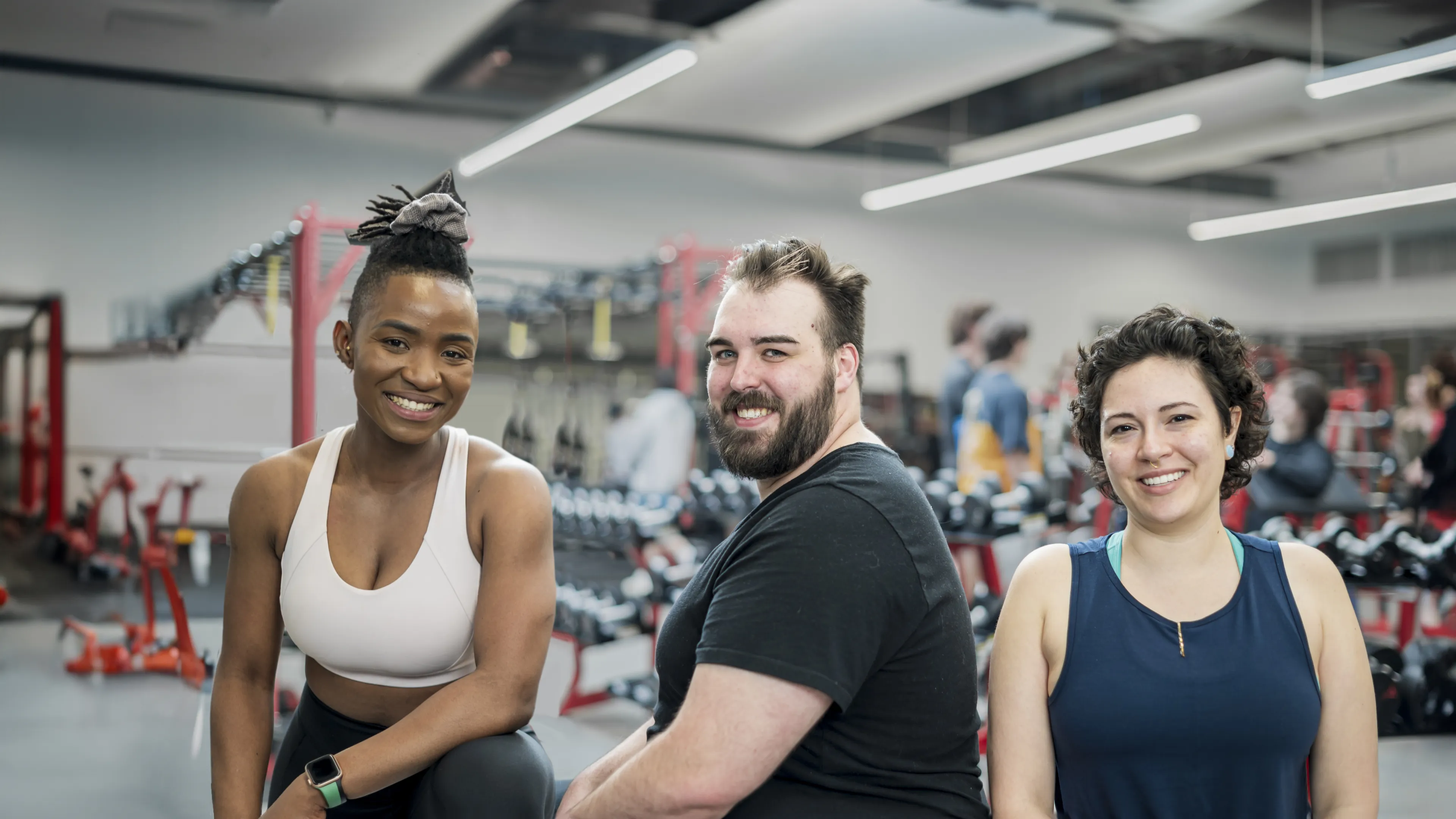 [Image] 3 smiling people in fitness centre