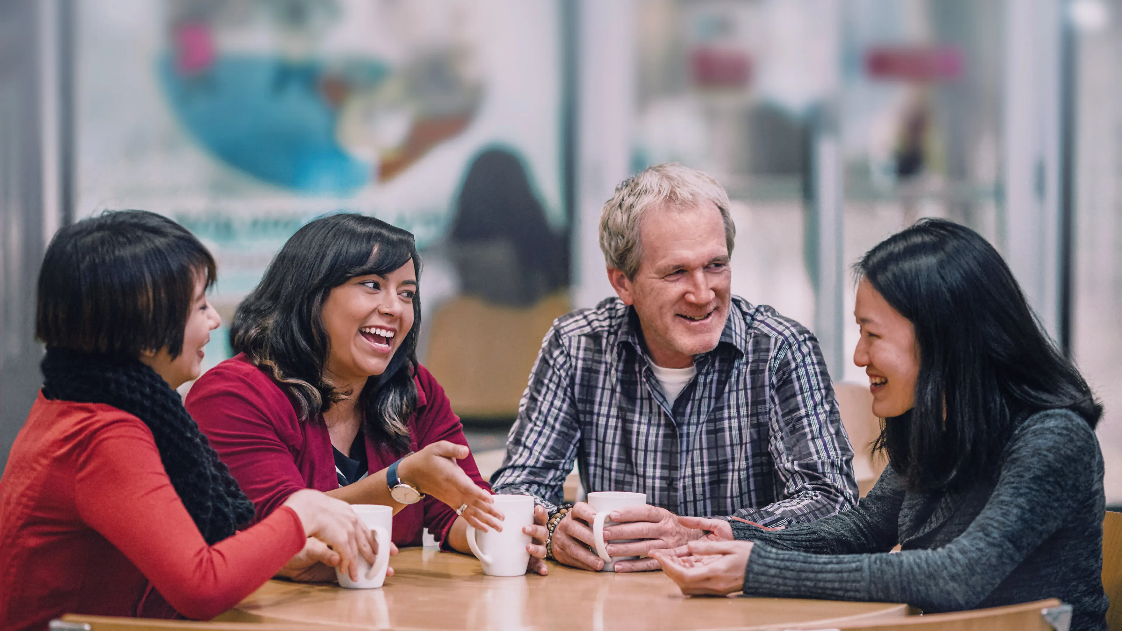 Group of people sitting together at a table and talking