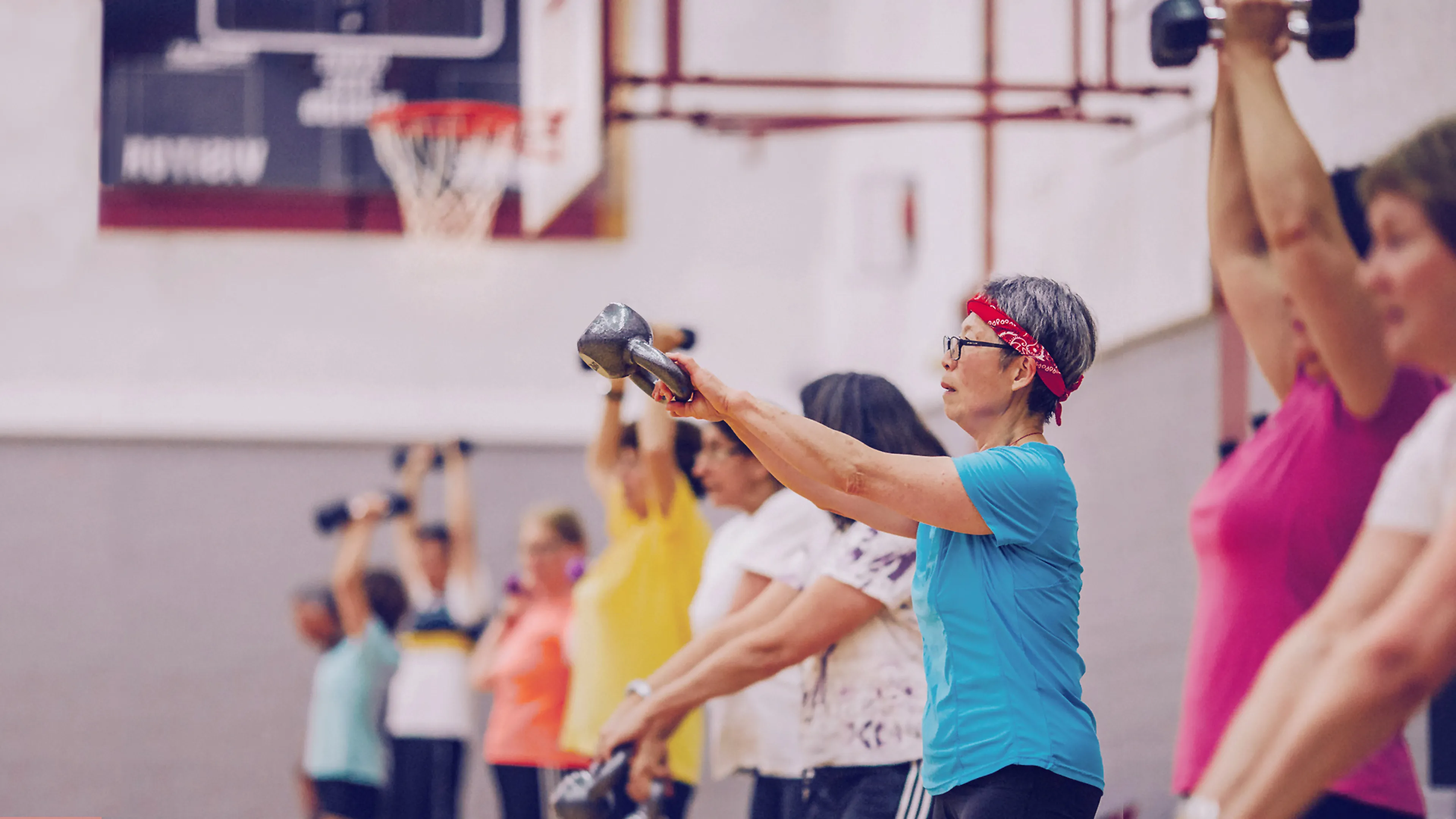 Group of women in an exercise class using weights