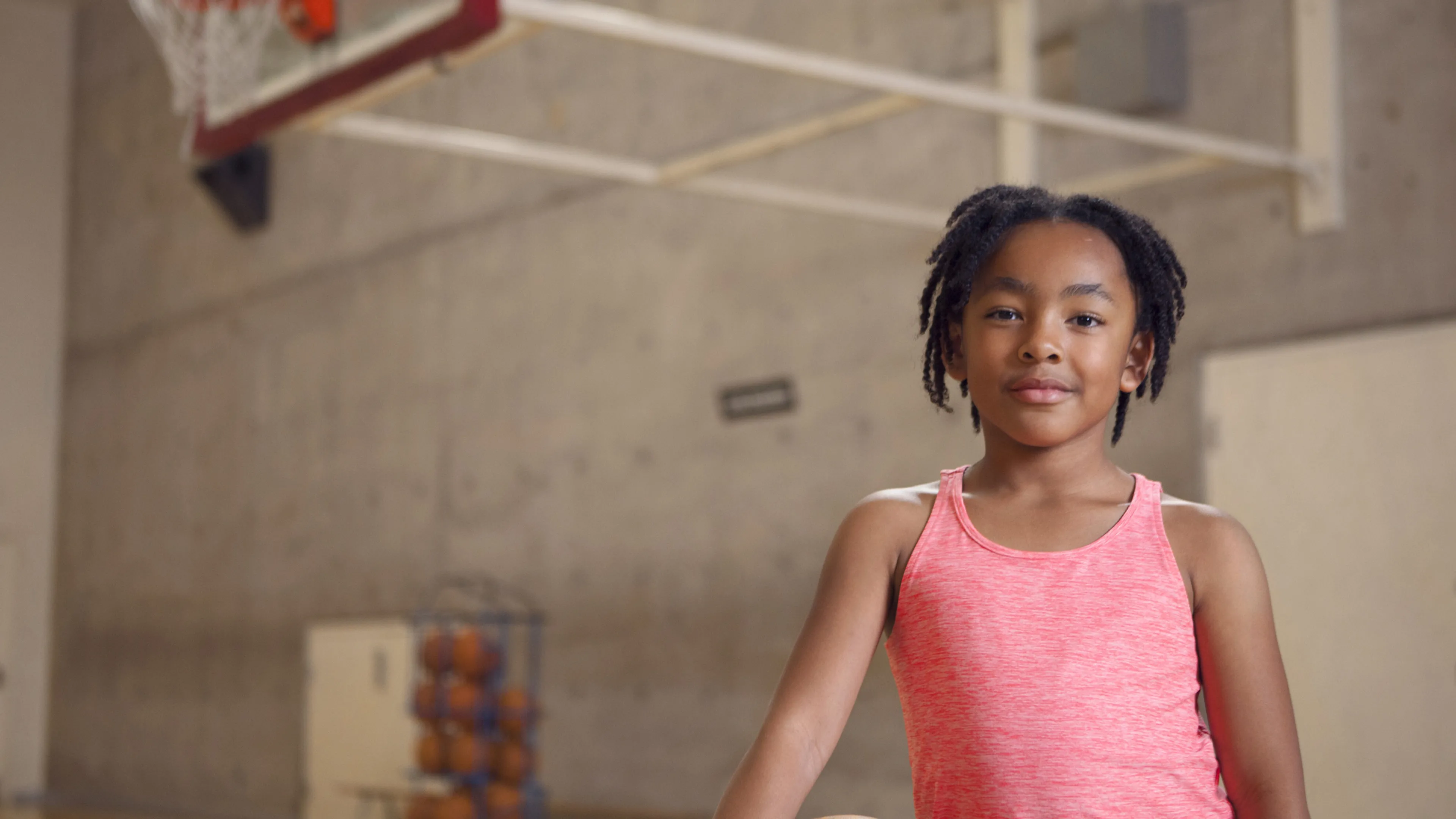 Youth with basketball in a gymnasium