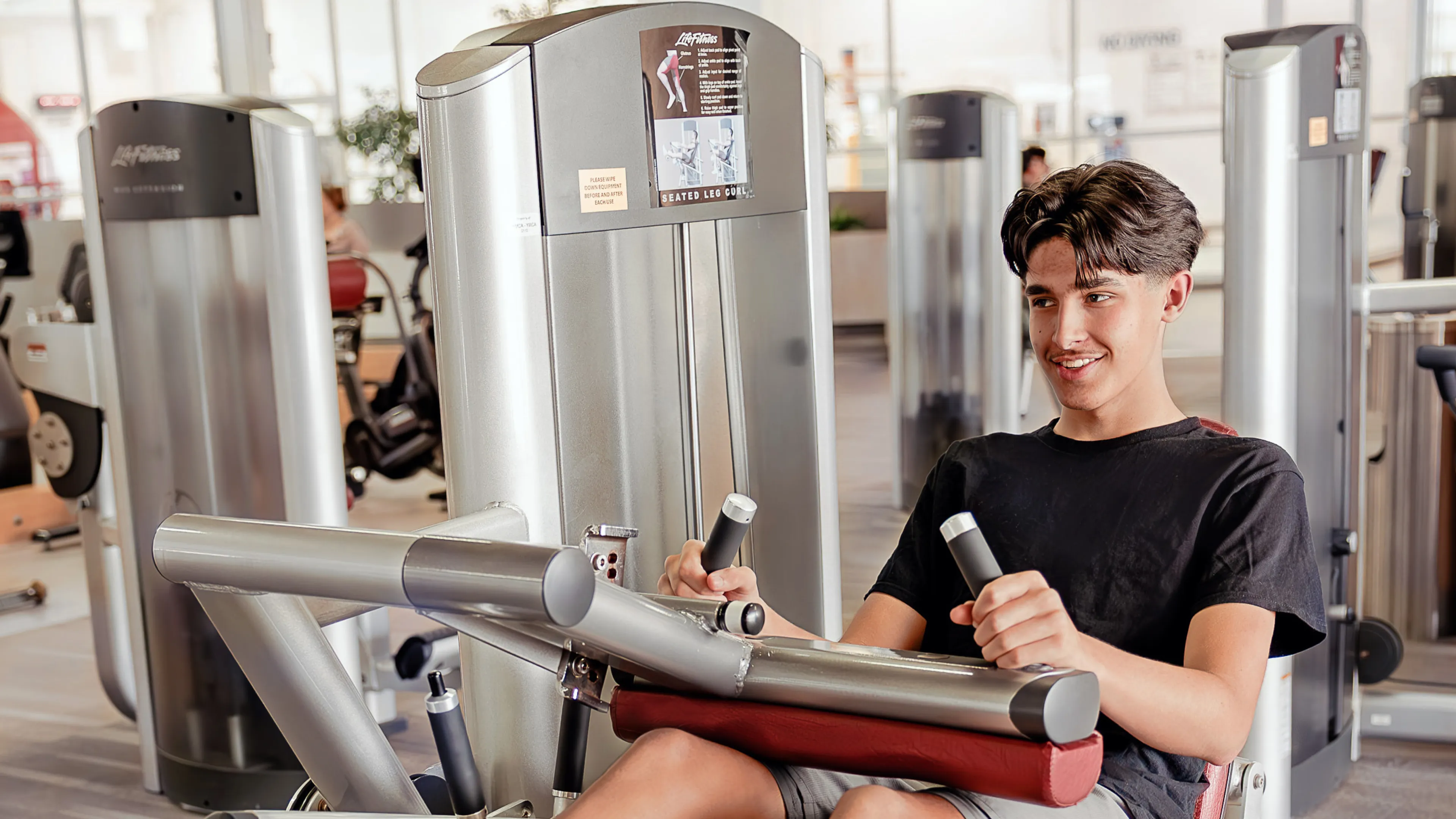 Teen boy using fitness centre at West Portage Y