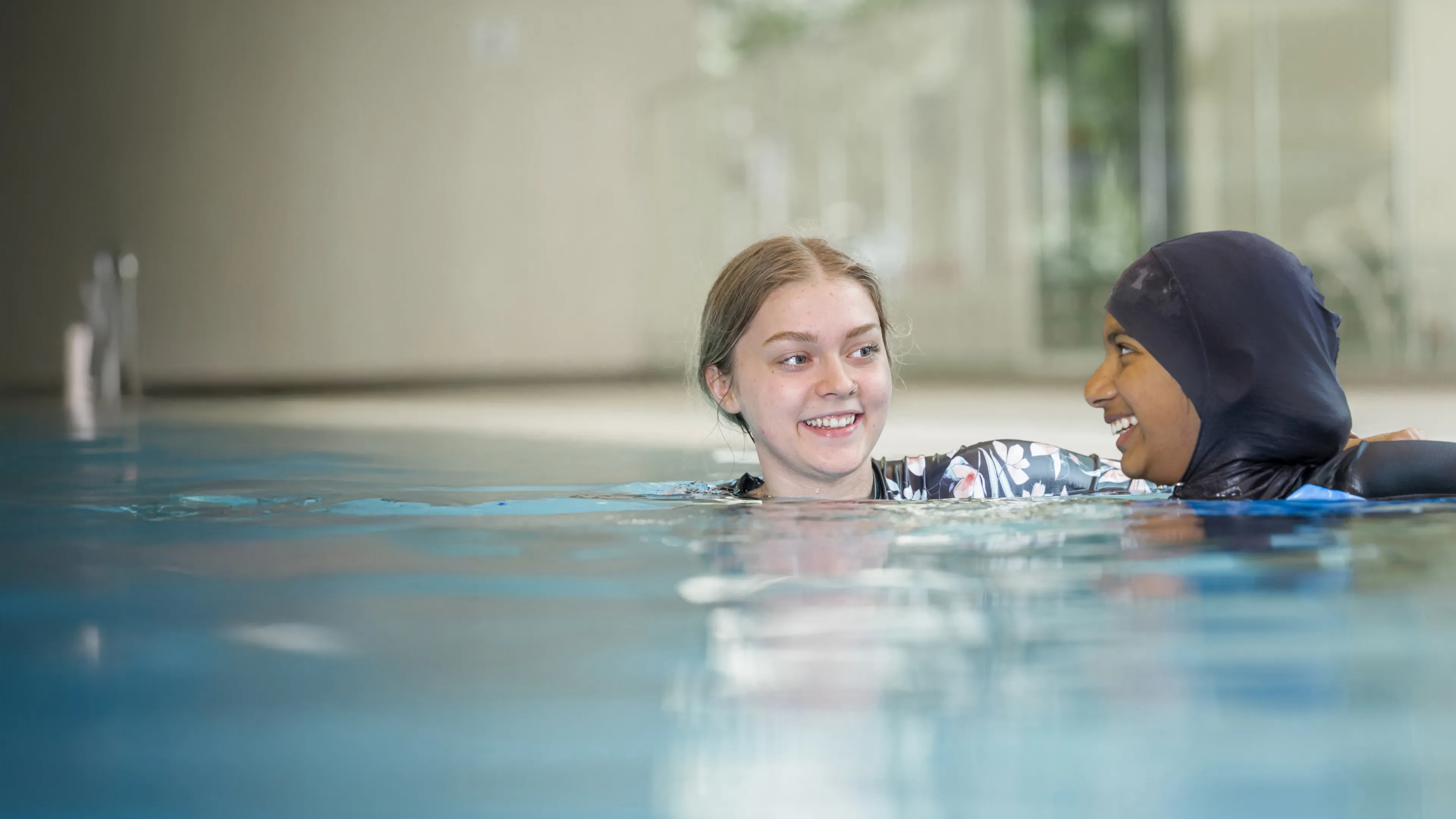 Two teen girls enjoy the pool