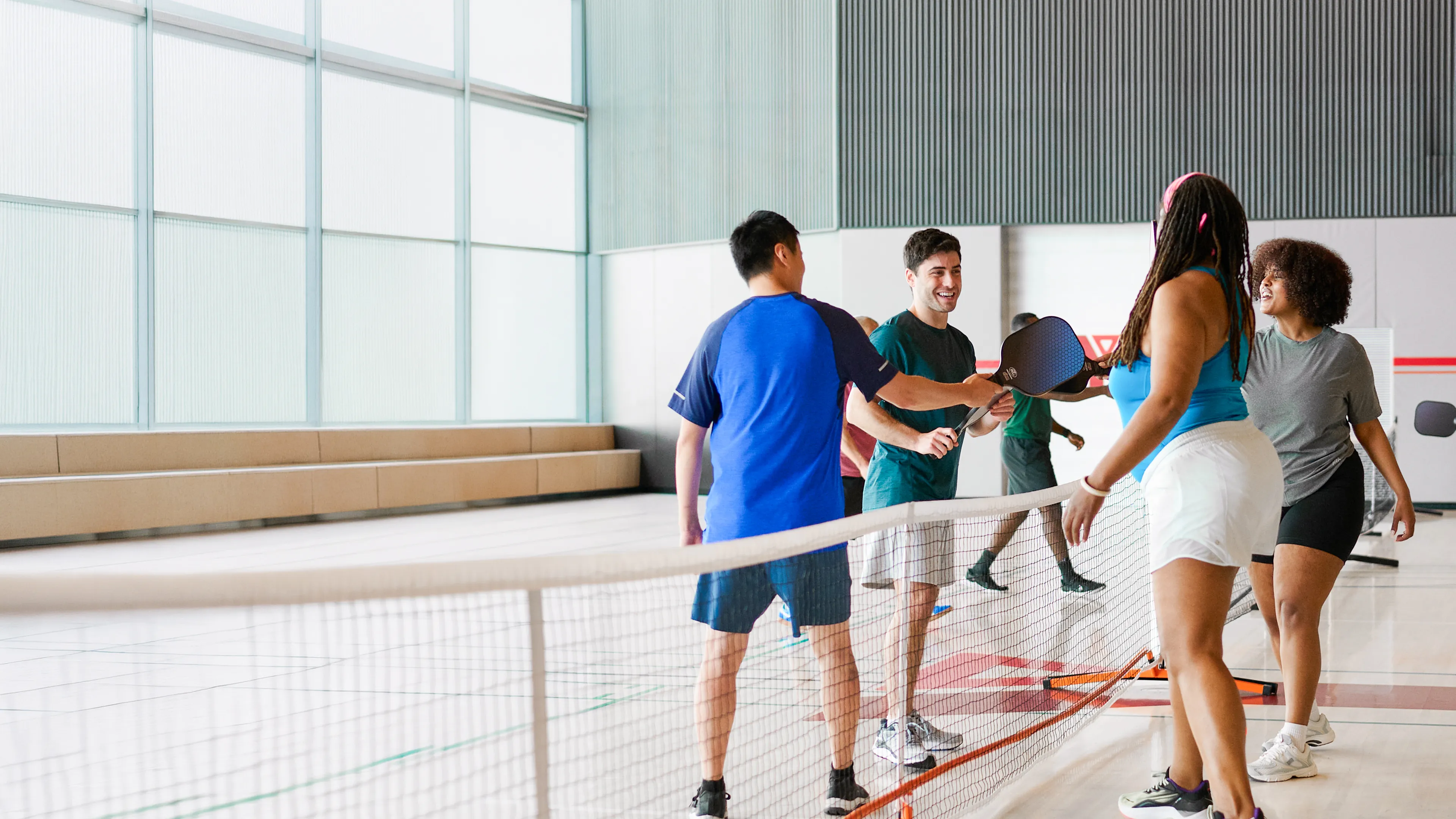 group of adults playing pickleball at the Y