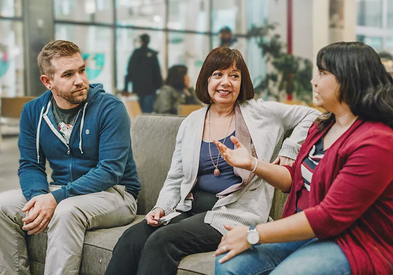 Three People Sitting and Talking