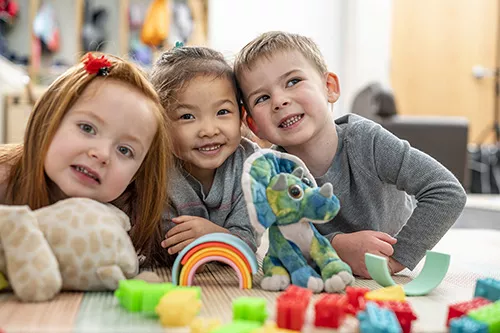 Three Children Playing with Toys