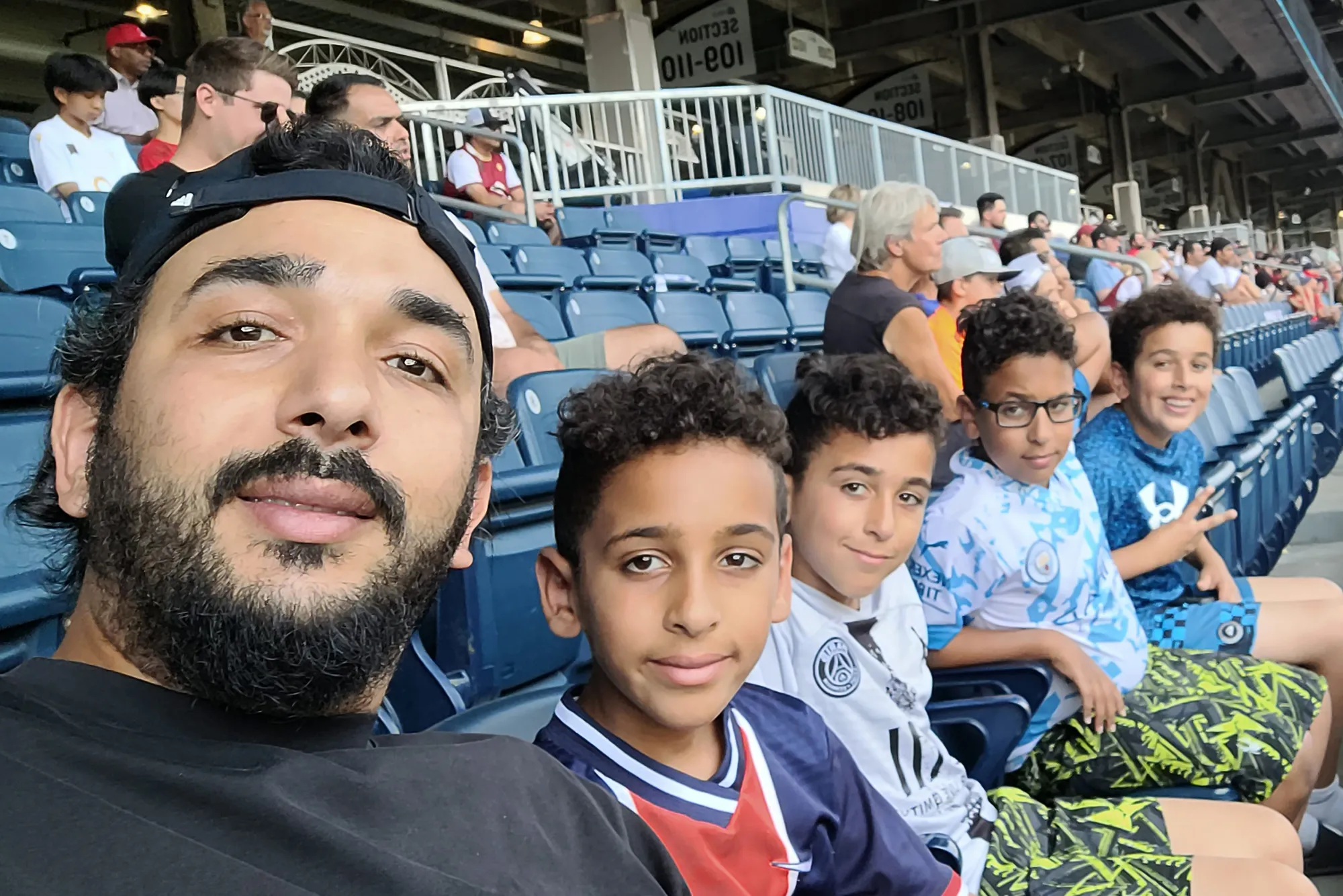Image of Fekiri family father and sons at a baseball game