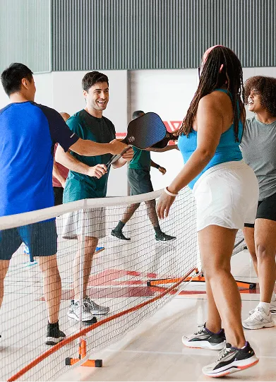 Pickleball players touching paddles before match