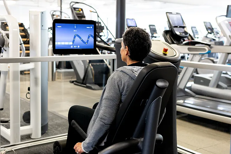 Woman Using EGYM Machine