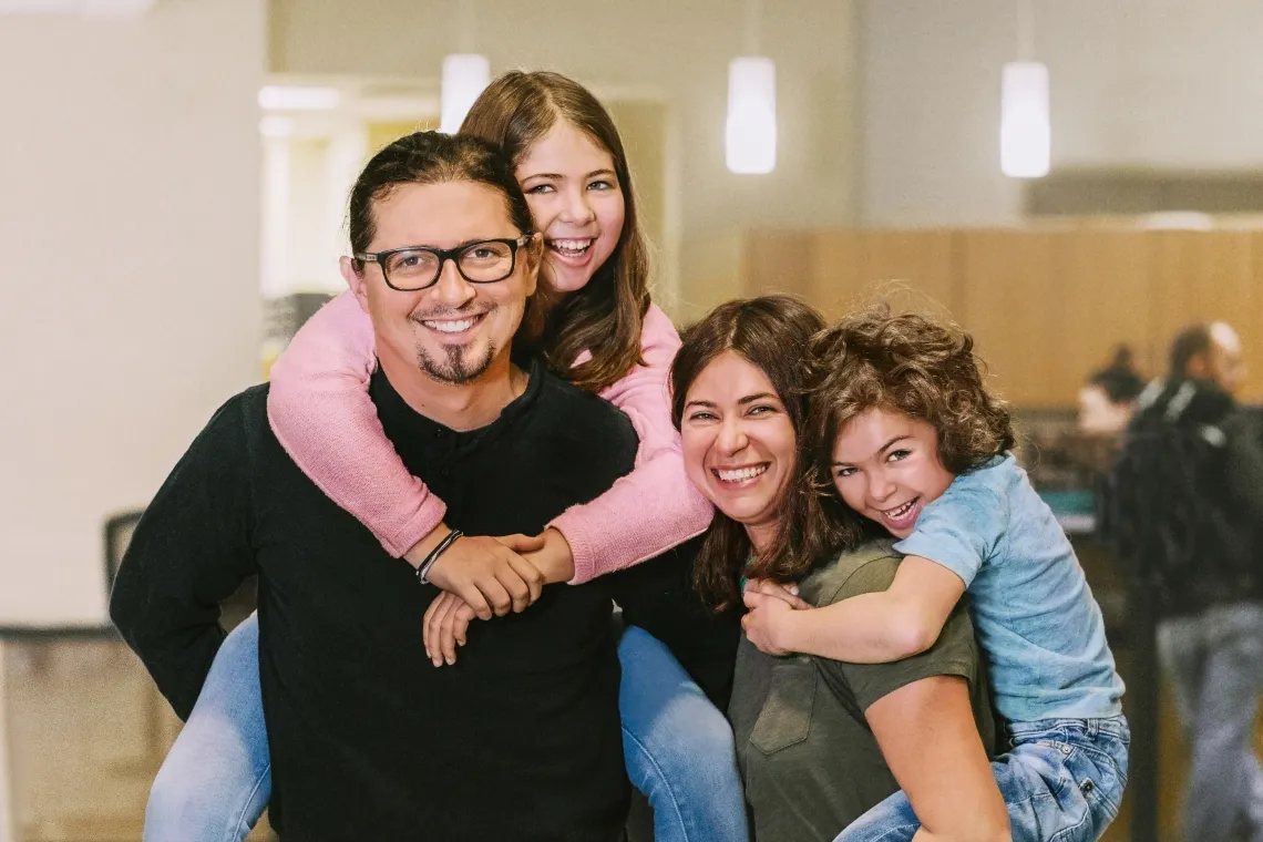 Family of four smiling