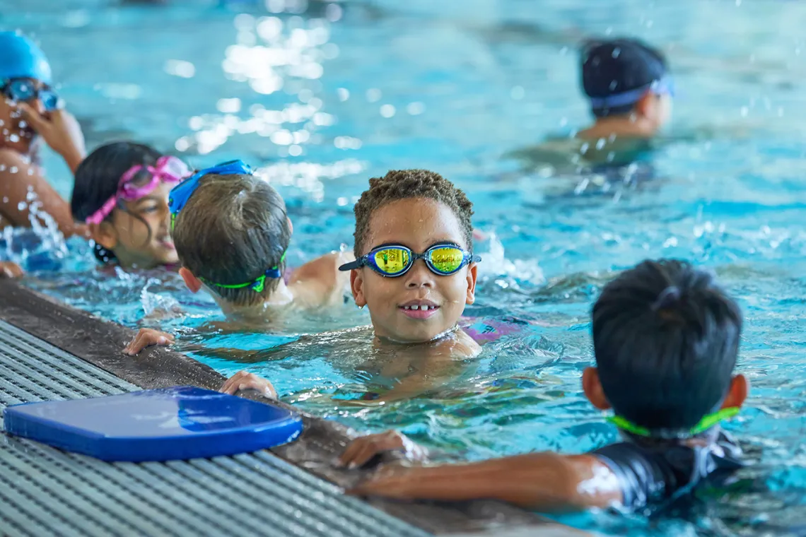 group of children wearing goggles in the pool