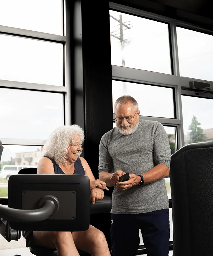 Man showing woman a phone