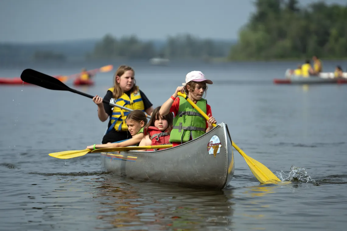young campers canoeing on lake
