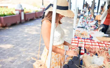 women browsing tables at an outdoor market