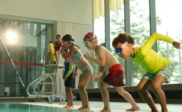 kids jumping into pool