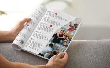 hands holding open a program guide