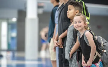 smiling youth with backpacks